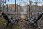 Fire pit in small fenced in area with river views